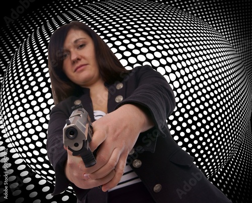 Photo: woman with handgun with grid background woman with handgun with grid background