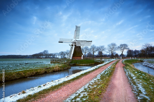 Photo: windmill by rural road after sunset windmill by rural road after sunset