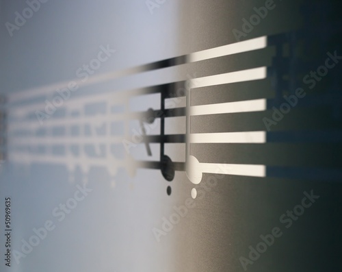 Photo: Musical notes on frosted glass, art background Musical notes on frosted glass, art background