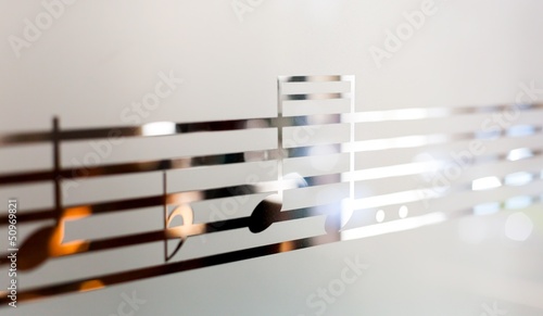 Photo: Musical notes on frosted glass, art background Musical notes on frosted glass, art background