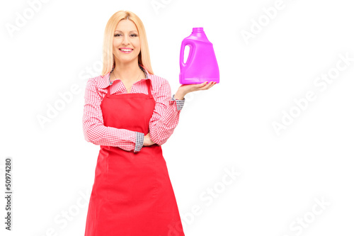 Photo: Housewife holding a bottle of detergent and posing Housewife holding a bottle of detergent and posing