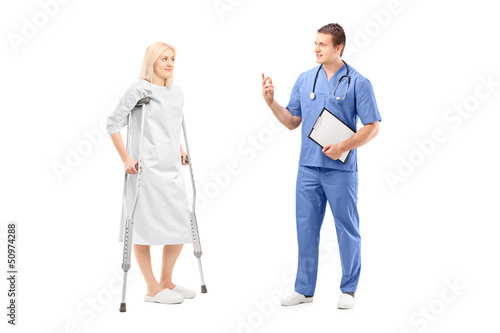 Photo: Full length portrait of a blond female patient in hospital gown Full length portrait of a blond female patient in hospital gown