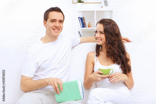 Photo: Young happy couple at hone together s Young happy couple at hone together s