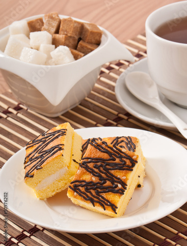 Photo: Slice of sponge cake with tea and sugar Slice of sponge cake with tea and sugar