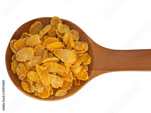 Photo: Spoonful of cornflakes isolated over white background Spoonful of cornflakes isolated over white background