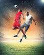 two football players striking the ball
