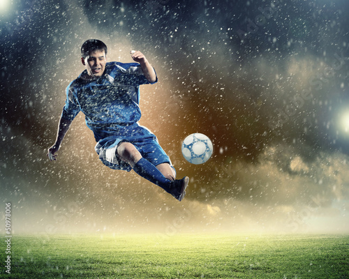 Photo: football player striking the ball football player striking the ball