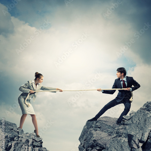 Photo: People pull the rope. People pull the rope.