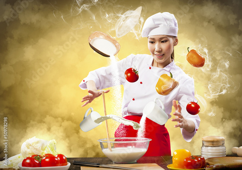 Photo: Asian female cooking with magic Asian female cooking with magic