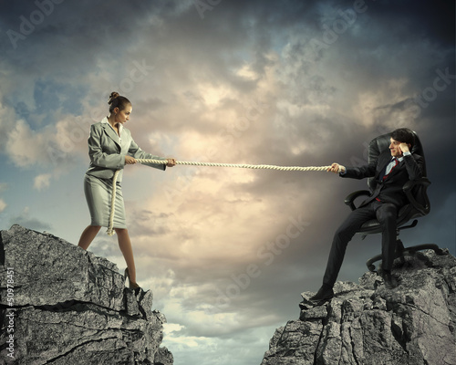 Photo: People pull the rope. People pull the rope.