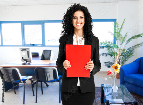 Photo: Young businesswoman in her office Young businesswoman in her office