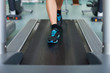 fitness woman legs on a treadmill in fitness sport club