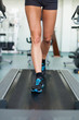 fitness woman legs on a treadmill in fitness sport club