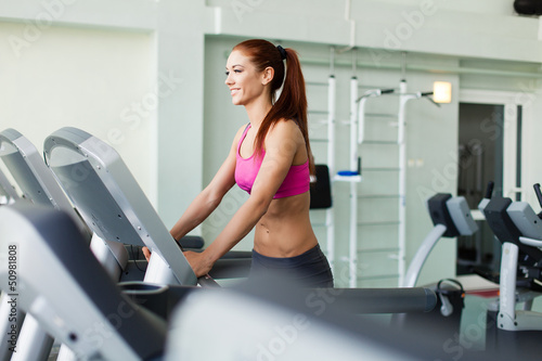 Photo: fitness model runs on treadmill is engaged in fitness sport club fitness model runs on treadmill is engaged in fitness sport club