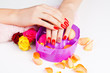girl with bright red polish on the nails in salon