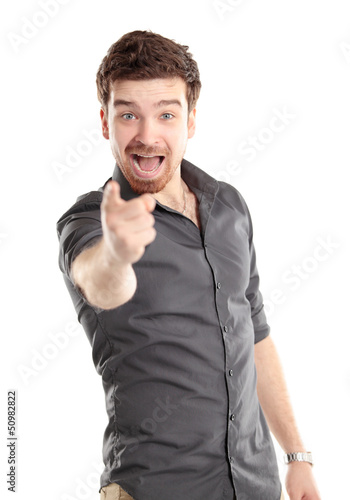 Photo: Portrait of smiling handsome man pointing at you over white Portrait of smiling handsome man pointing at you over white