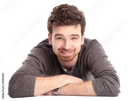 Photo: Man lying on floor with arms crossed Man lying on floor with arms crossed