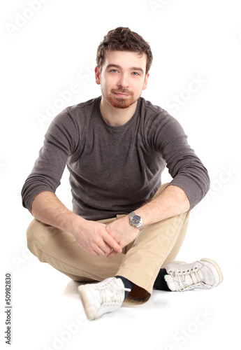 Photo: Flirtatious man sitting on the floor Flirtatious man sitting on the floor