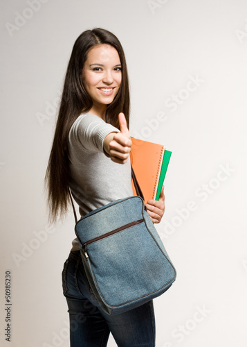 Photo: Confident young brunette student. Confident young brunette student.