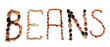 The word Beans is lined by different types of beans isolated