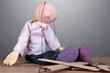 Photo: Wooden puppet sitting on grey background Wooden puppet sitting on grey background