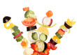 Sliced vegetables on wooden picks isolated on white