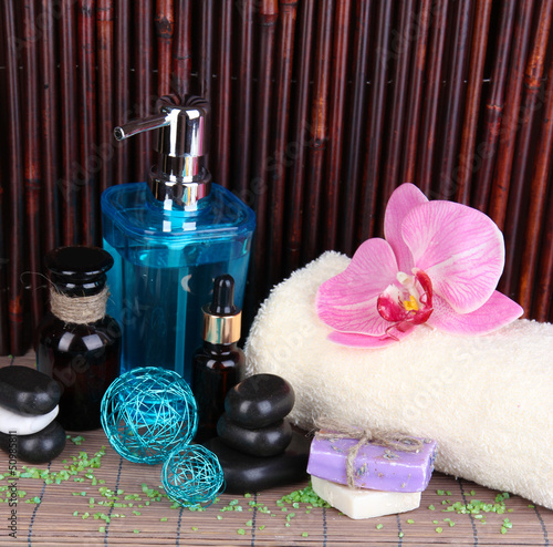 Photo: Beautiful spa setting near pool on bamboo background Beautiful spa setting near pool on bamboo background