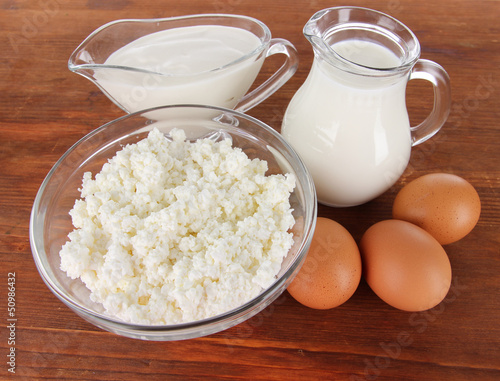 Photo: Dairy products and eggs on wooden background Dairy products and eggs on wooden background