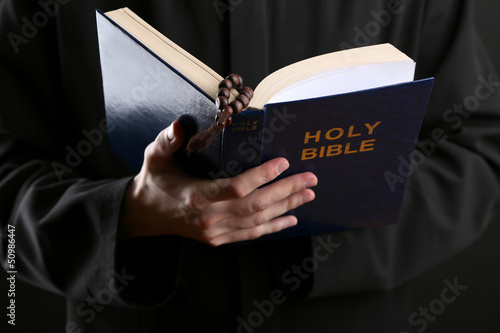 Photo: Priest reading from the holy bible, close up Priest reading from the holy bible, close up