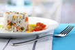 Delicious risotto with vegetables on table in cafe