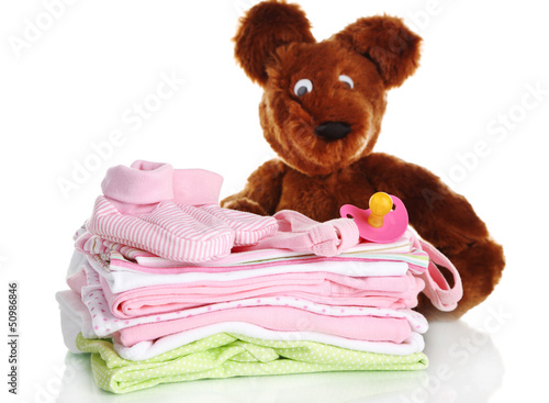 Photo: Pile of baby clothes isolated on white Pile of baby clothes isolated on white