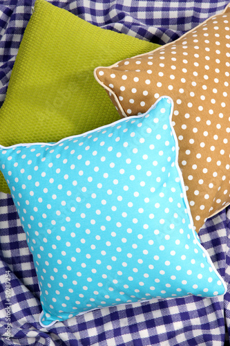 Photo: Three various pillows on plaid Three various pillows on plaid