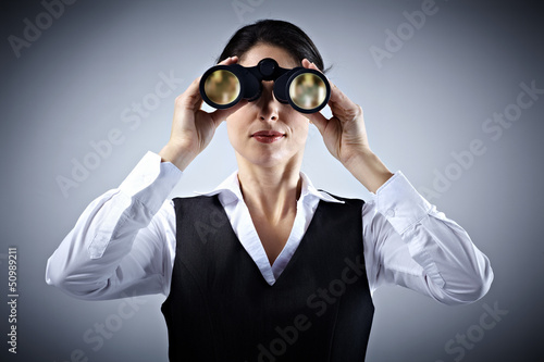 Photo: Business woman with binoculars. Business woman with binoculars.