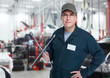 Auto mechanic with a wheel wrench.