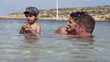 Happy family playing in the sea