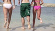Young friends running to the sea, super slow motion