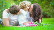 Happy family having fun outdoors in spring park. Slow motion