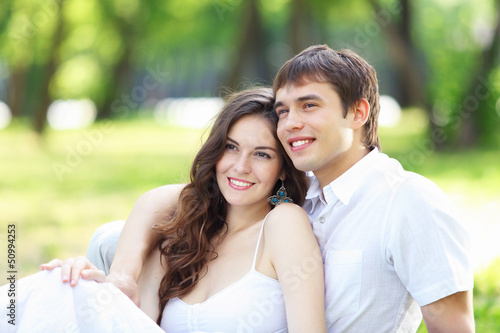 Photo: Young love Couple smiling under blue sky Young love Couple smiling under blue sky