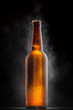 Cold beer bottle with drops, frost and vapour on black