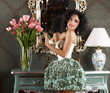 Glamorous Woman in Retro Interior. Vase of Flowers. Reflection