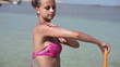 Woman applying sun block lotion on her arm