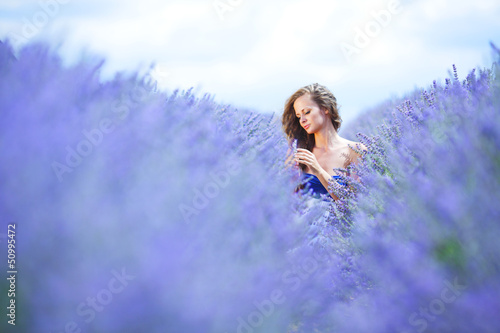 Photo: Woman standing on a lavender field Woman standing on a lavender field