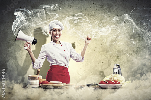 Photo: Asian female cook holding megaphone Asian female cook holding megaphone