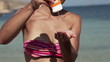 Video: Woman applying sun block lotion on her neck, super slow motion Woman applying sun block lotion on her neck, super slow motion