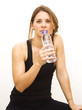 Beautiful woman drinking water after playing sports