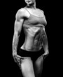 Muscular strong woman on a black background