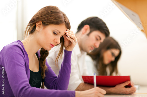 Photo: Young students studying in a library Young students studying in a library