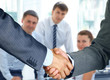 Photo: Business handshake and business people Business handshake and business people