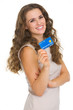 Portrait of happy young woman holding credit card