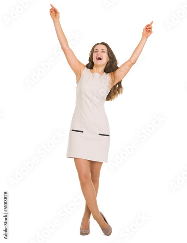 Photo: Full length portrait of happy young woman rejoicing success Full length portrait of happy young woman rejoicing success